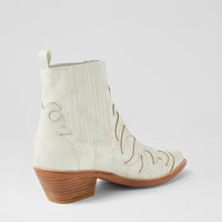 White cowboy boot with brown sole on a light gray background