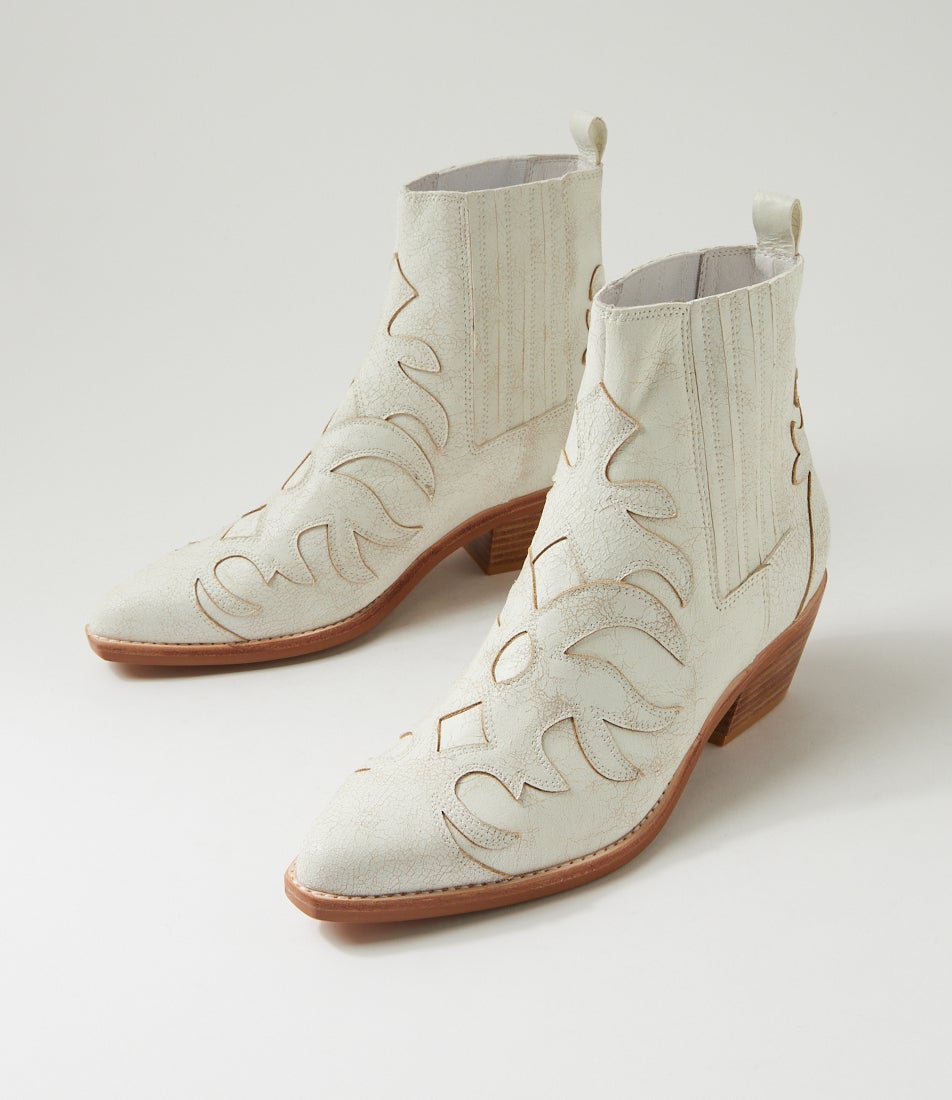 White cowboy boot with brown sole on a light gray background