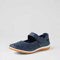 A navy blue Mary Jane-style shoe with perforated detailing on the toe, a hook-and-loop strap, and a white midsole with an orange outsole, shown against a light gray background.
